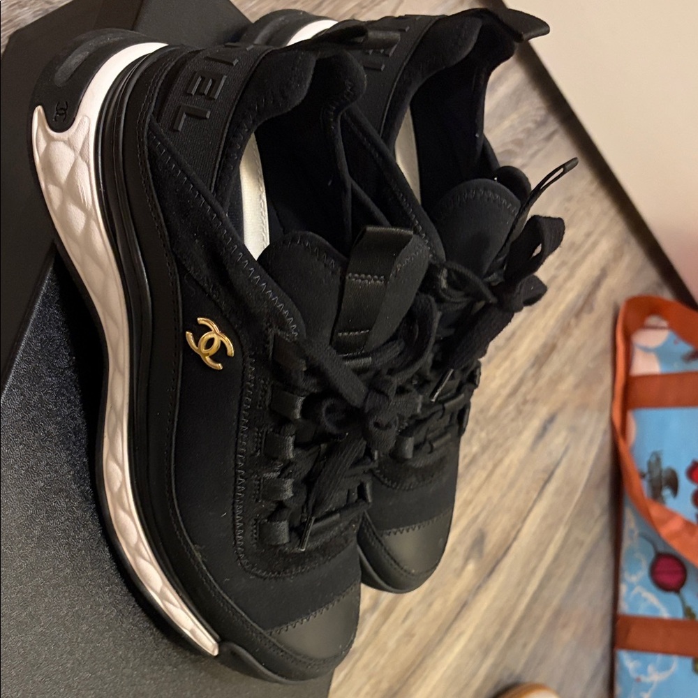 CHANEL Black and White Sneakers with Gold Accent